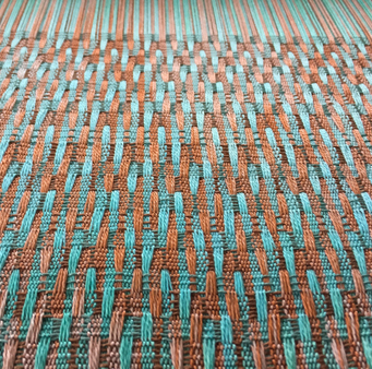 closeup of terra cotta-turquoise on the loom