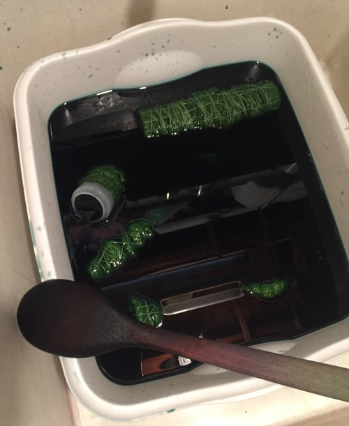 green socks in the dye bath