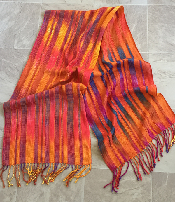 sunrise sunset shawl with orange laid flat