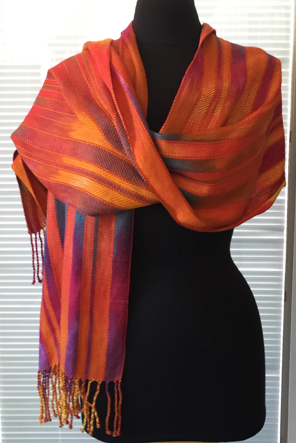 sunrise sunset shawl with orange on mannequin