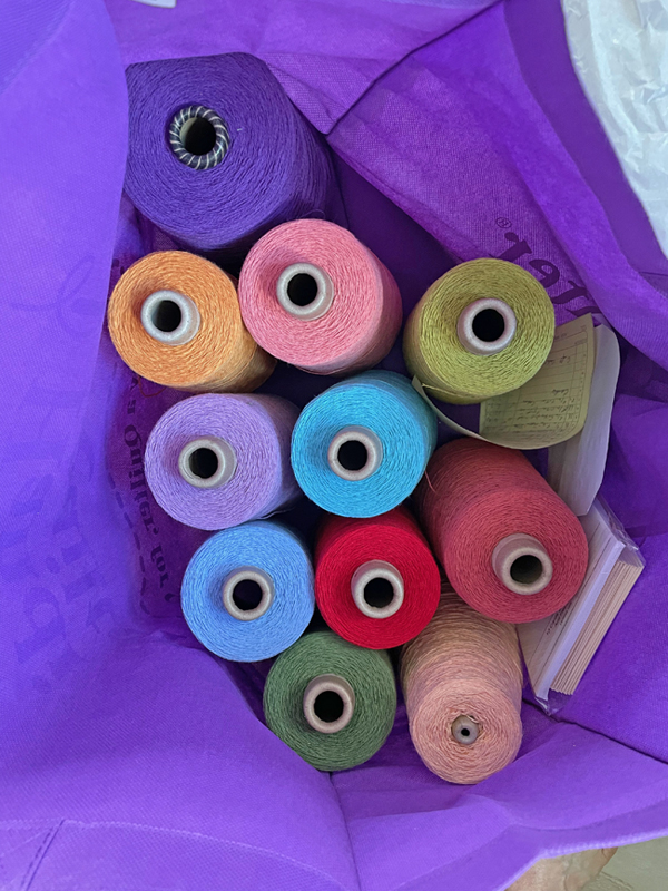 11 cones of yarn in a bag
